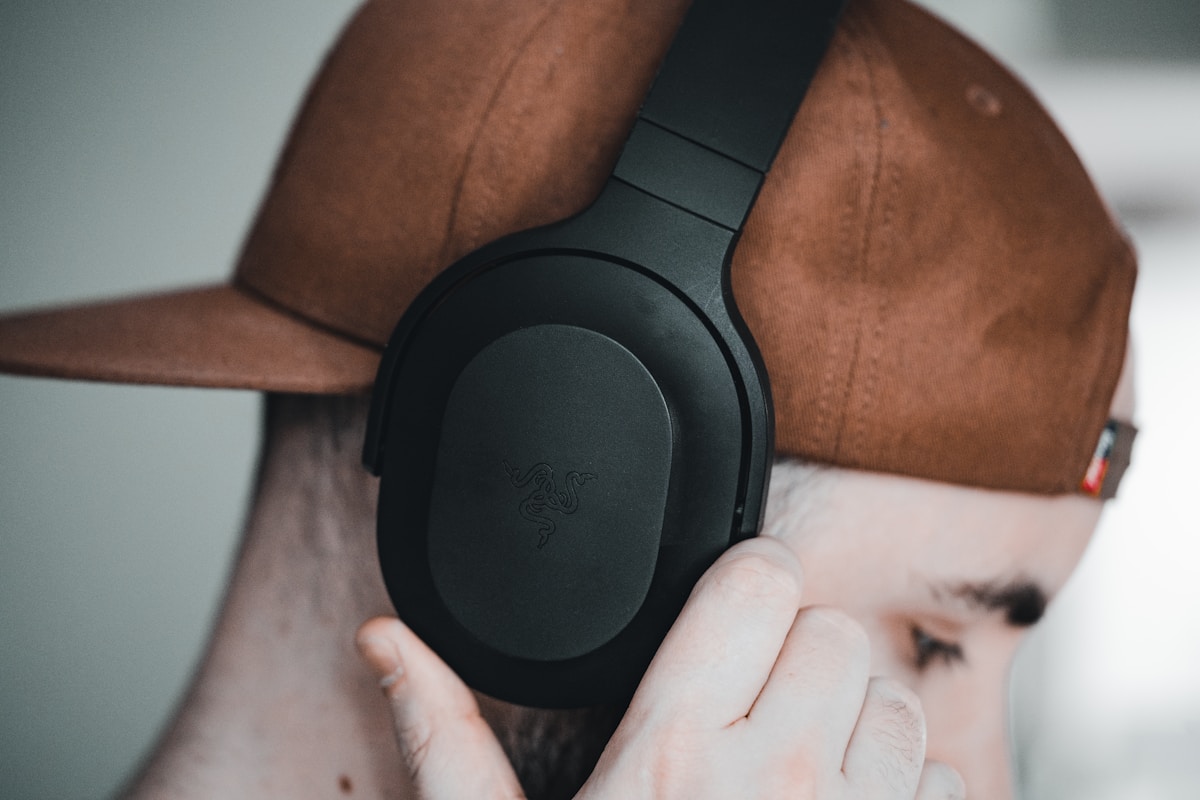 a man wearing a brown hat and headphones