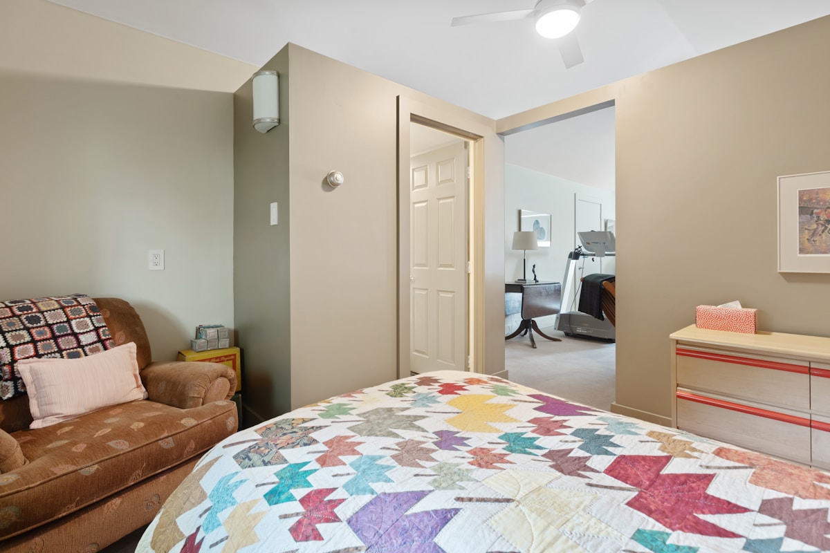 a bedroom with a bed and a chair