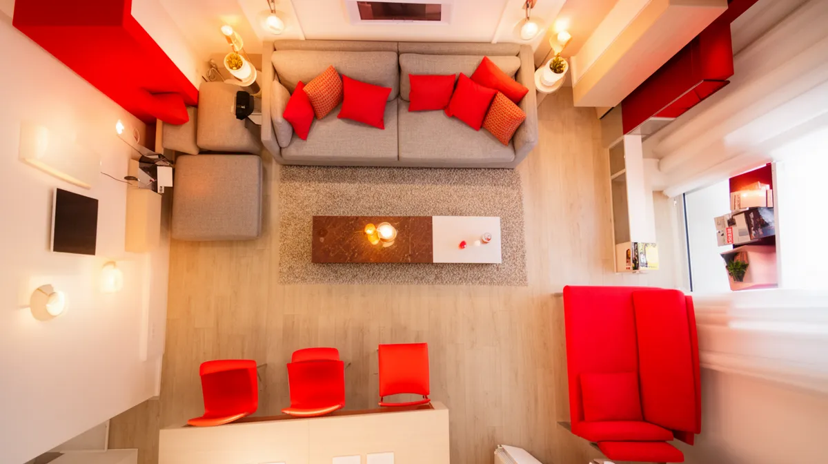 Cozy living room with red accents and modern furniture.
