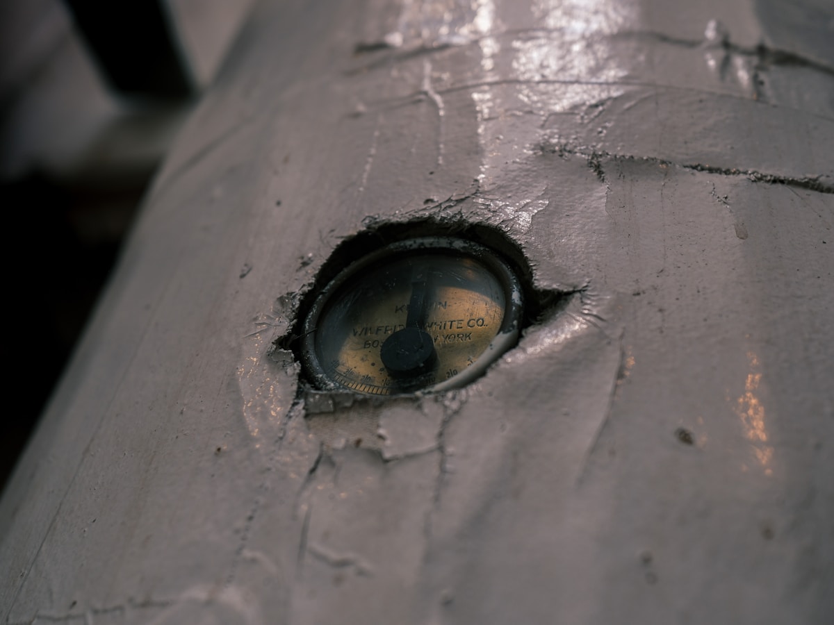 Close-up of a weathered, metallic eye on a cylindrical object.