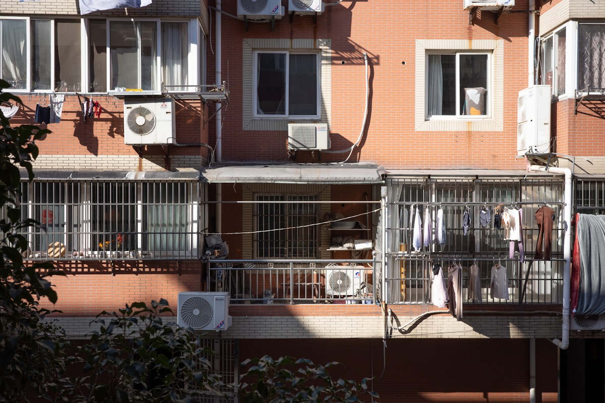 Apartment building exterior with balconies and air conditioners