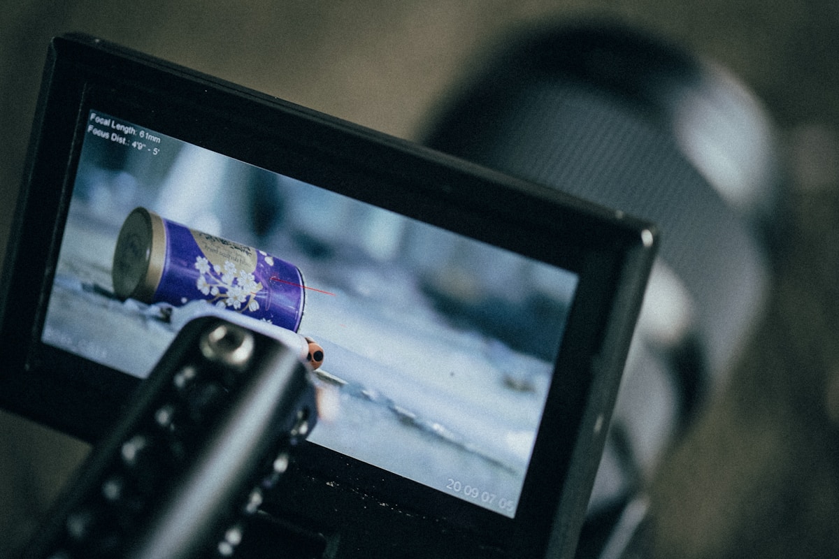 a person holding a camera with a video on it