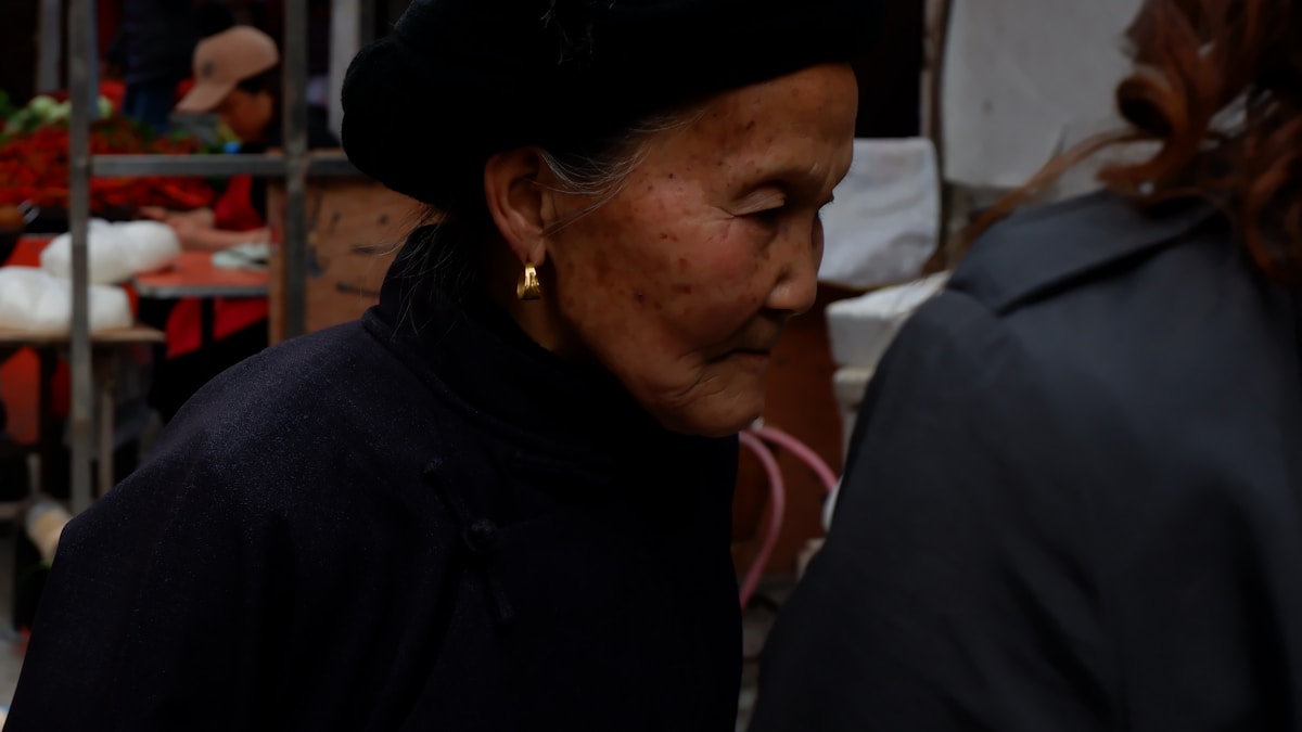 woman in black hoodie wearing gold earring