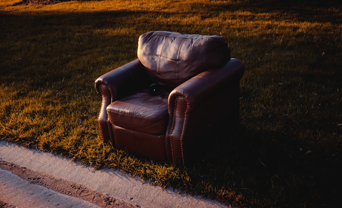 black leather armchair on gray concrete floor