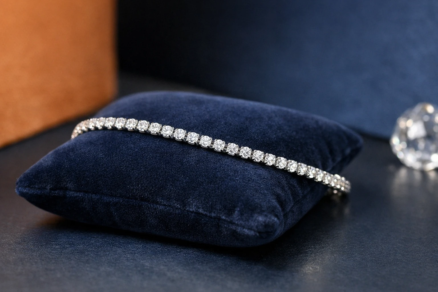 Elegant diamond tennis bracelet displayed on dark velvet cushion with professional jewelry lighting highlighting the brilliant diamonds and precious metal craftsmanship, luxury jewelry photography