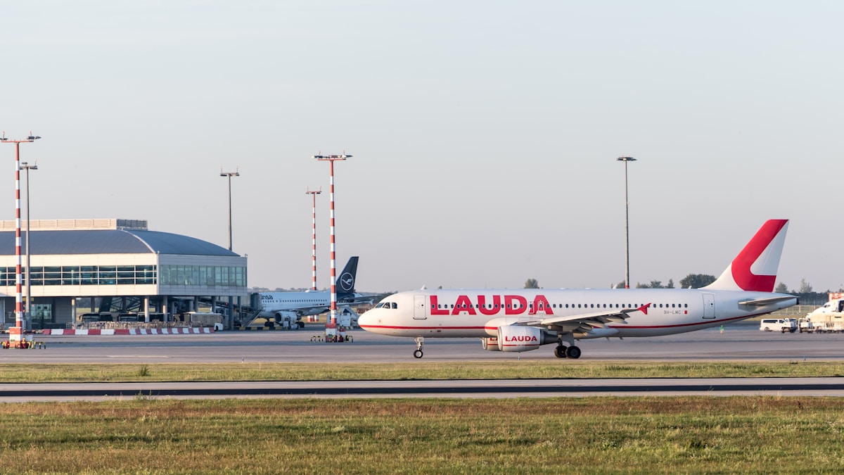 Aéroport avec avion de la compagnie Lauda sur la piste.