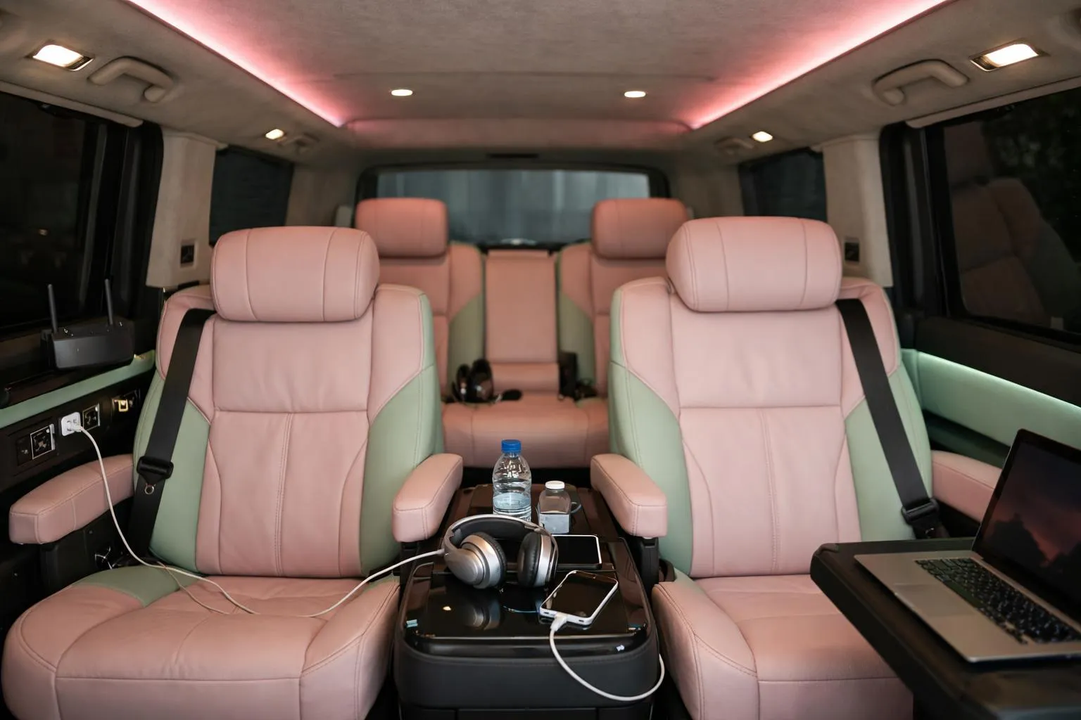 Luxurious black VTC minivan interior with premium leather seats, ambient lighting, professional WiFi equipment and charging stations visible, sophisticated atmosphere suitable for artists and technical crews during tours, Nancy region context