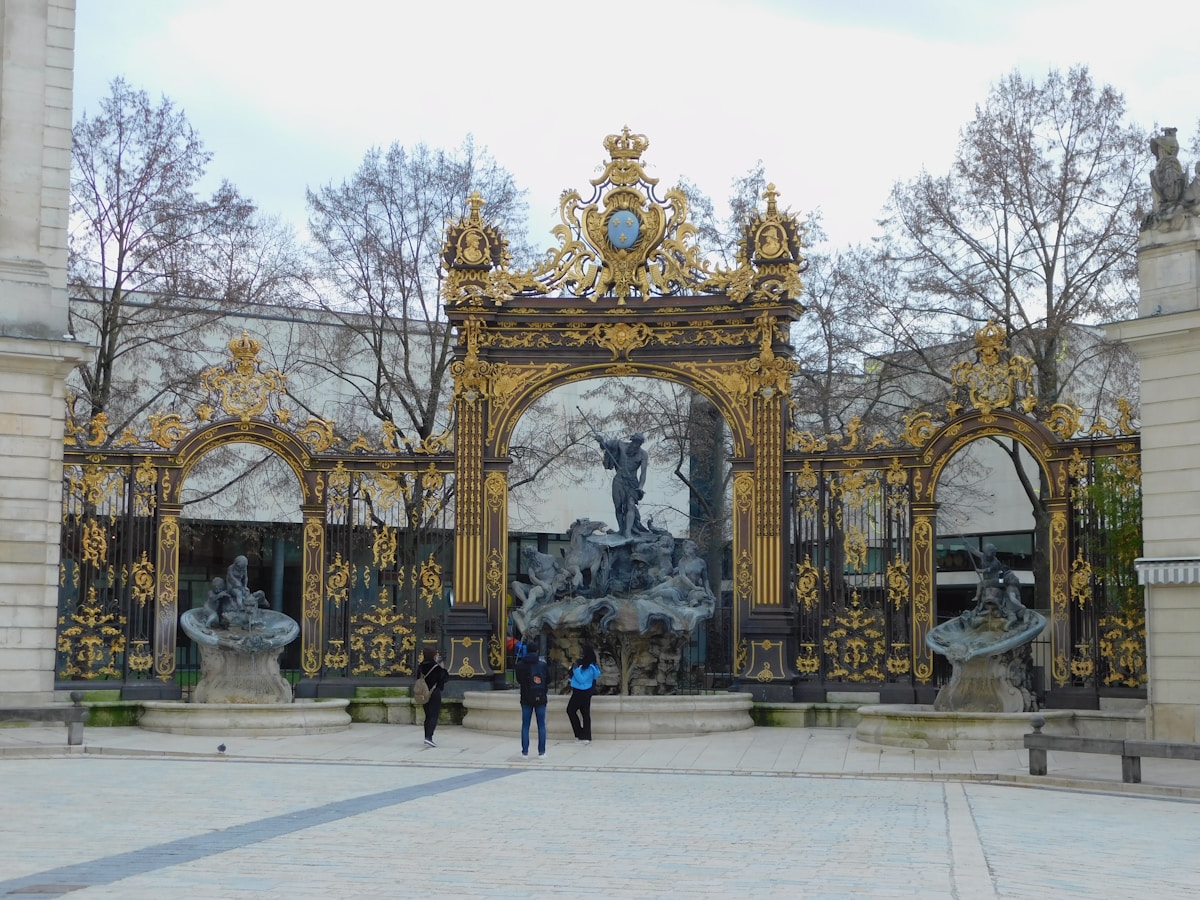 a couple of people that are standing in front of a gate