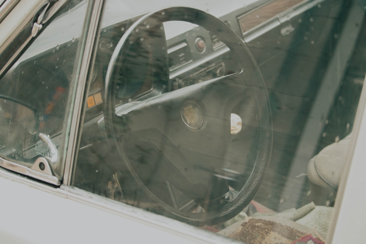 Vintage car dashboard with circular glass instrument.