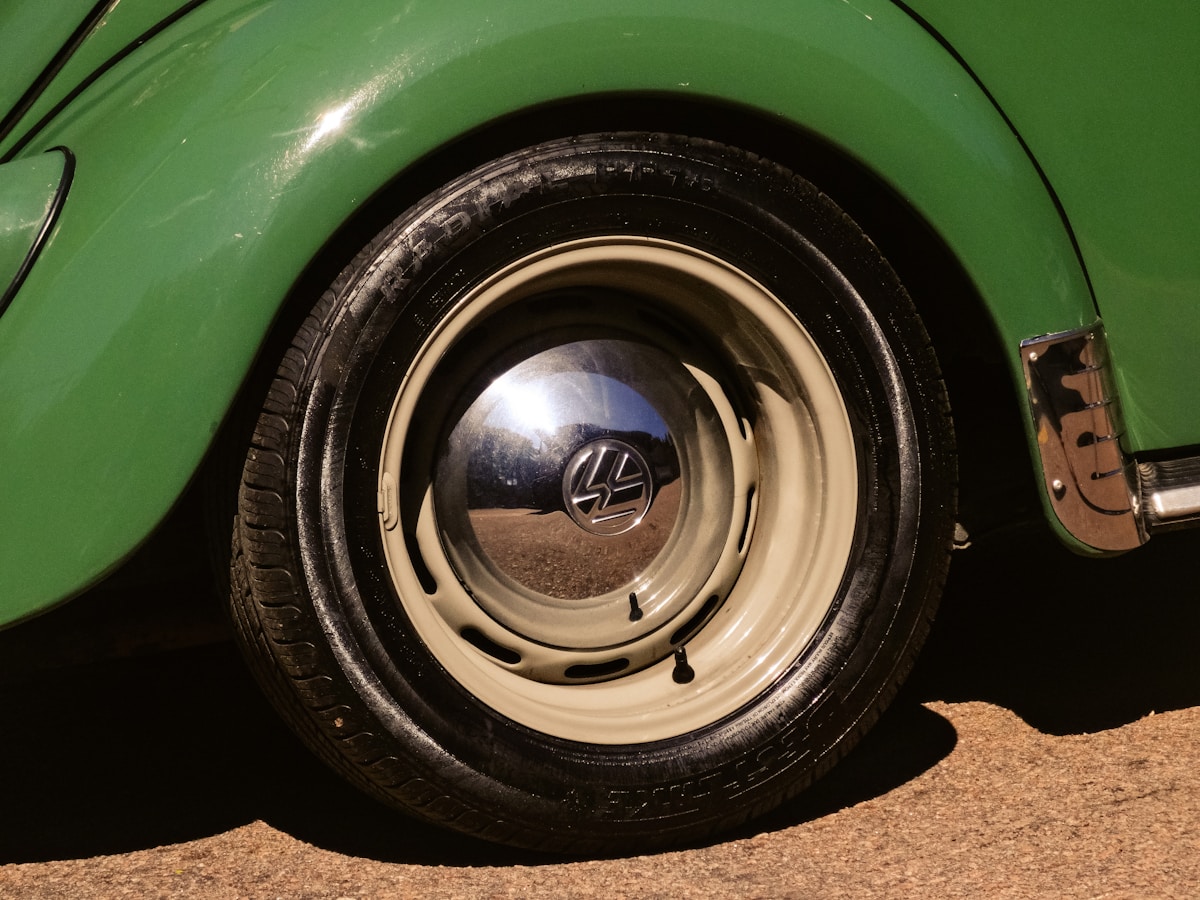 Close-up of a vintage green car wheel and tire