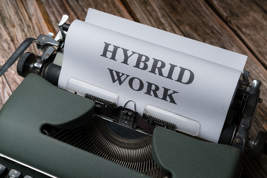 immobilier hybride et télétravail tendances - a typewriter with a sheet of paper that reads hybrid work