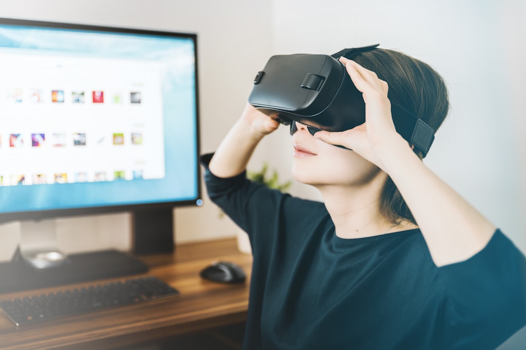 quel est le coût d'une visite virtuelle - woman using black VR headset beside computer