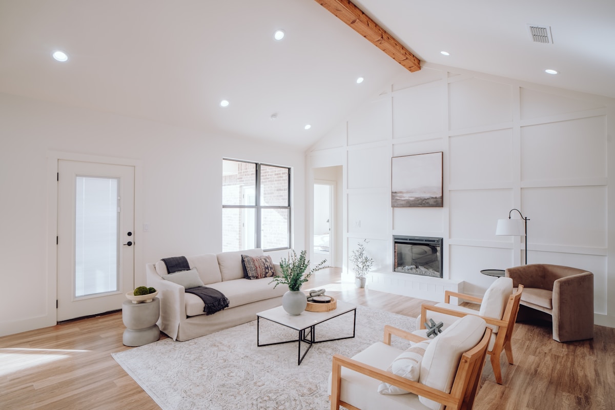 Salon lumineux avec meubles confortables et décoration épurée.