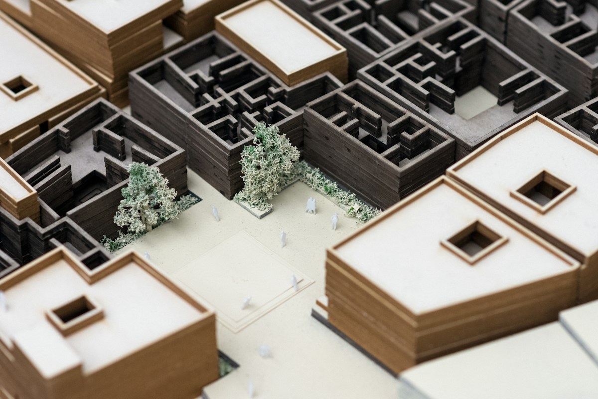 Maquette architecturale complexe avec bâtiments, arbres et cour intérieure