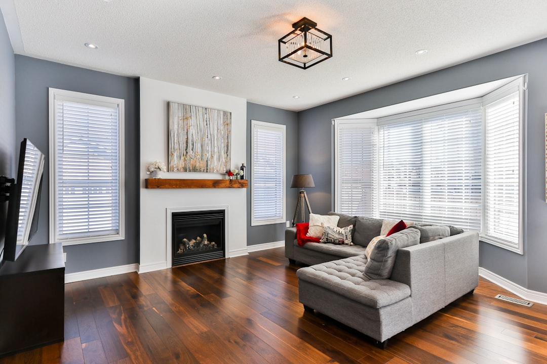amenagement sous pente prix - A professional interior photo of a well-organized attic bedroom with custom built-in wooden sto