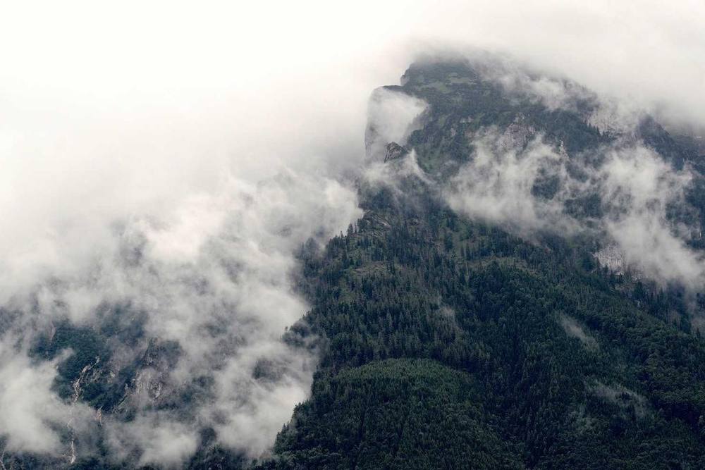 Mountain peak obscured by low-lying clouds.