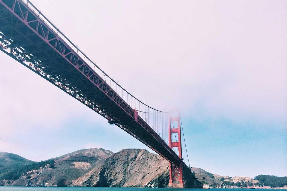 Golden Gate Bridge partially obscured by fog.